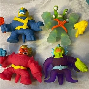 Goo Jit zu Action Figure Set for Kids - Blue, Green, Red, Purple